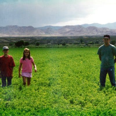 Chris, Steven, and Erica standing on the farm